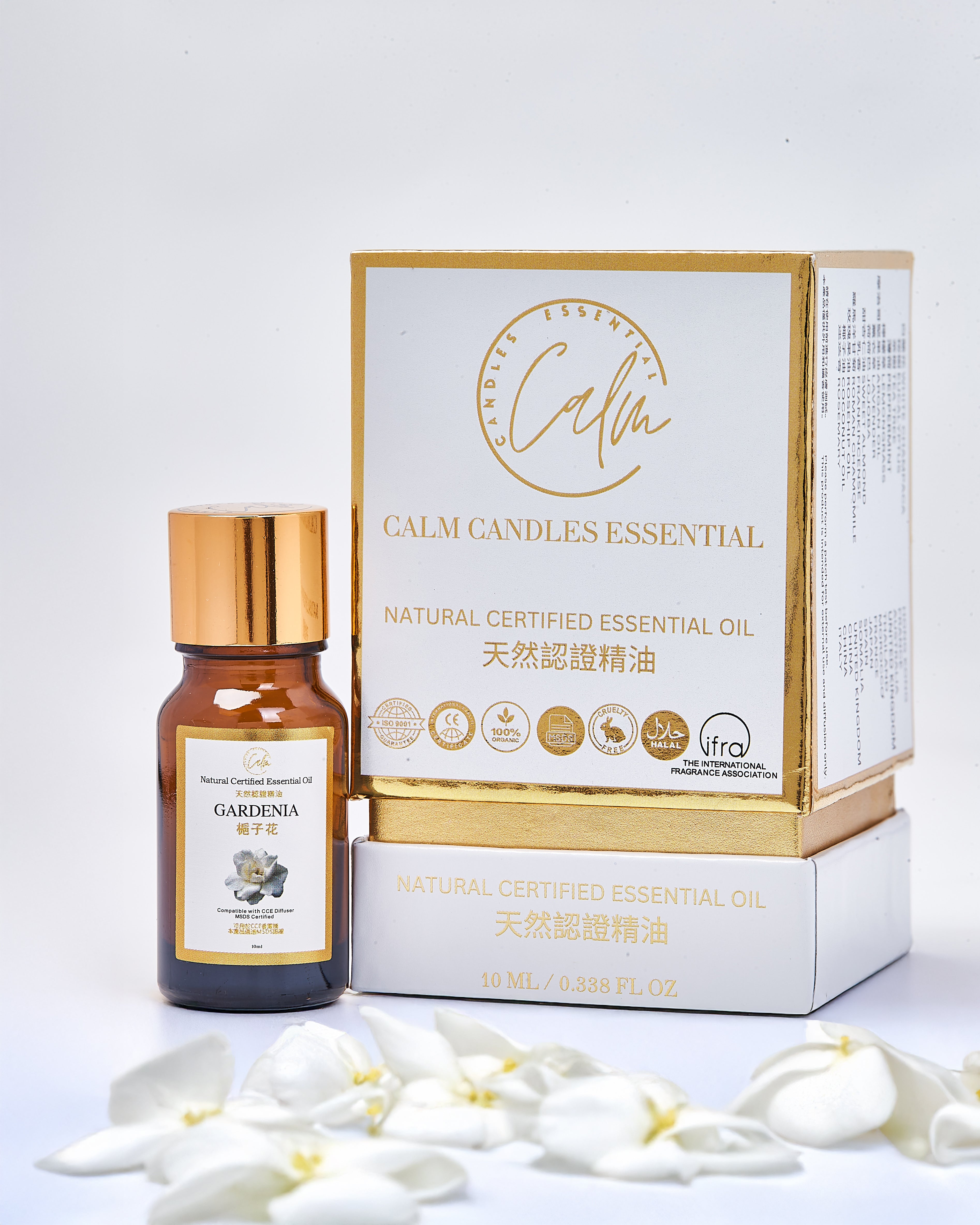 Calm candles essential oil bottle and packaging with white gardenia flowers on a light gray background