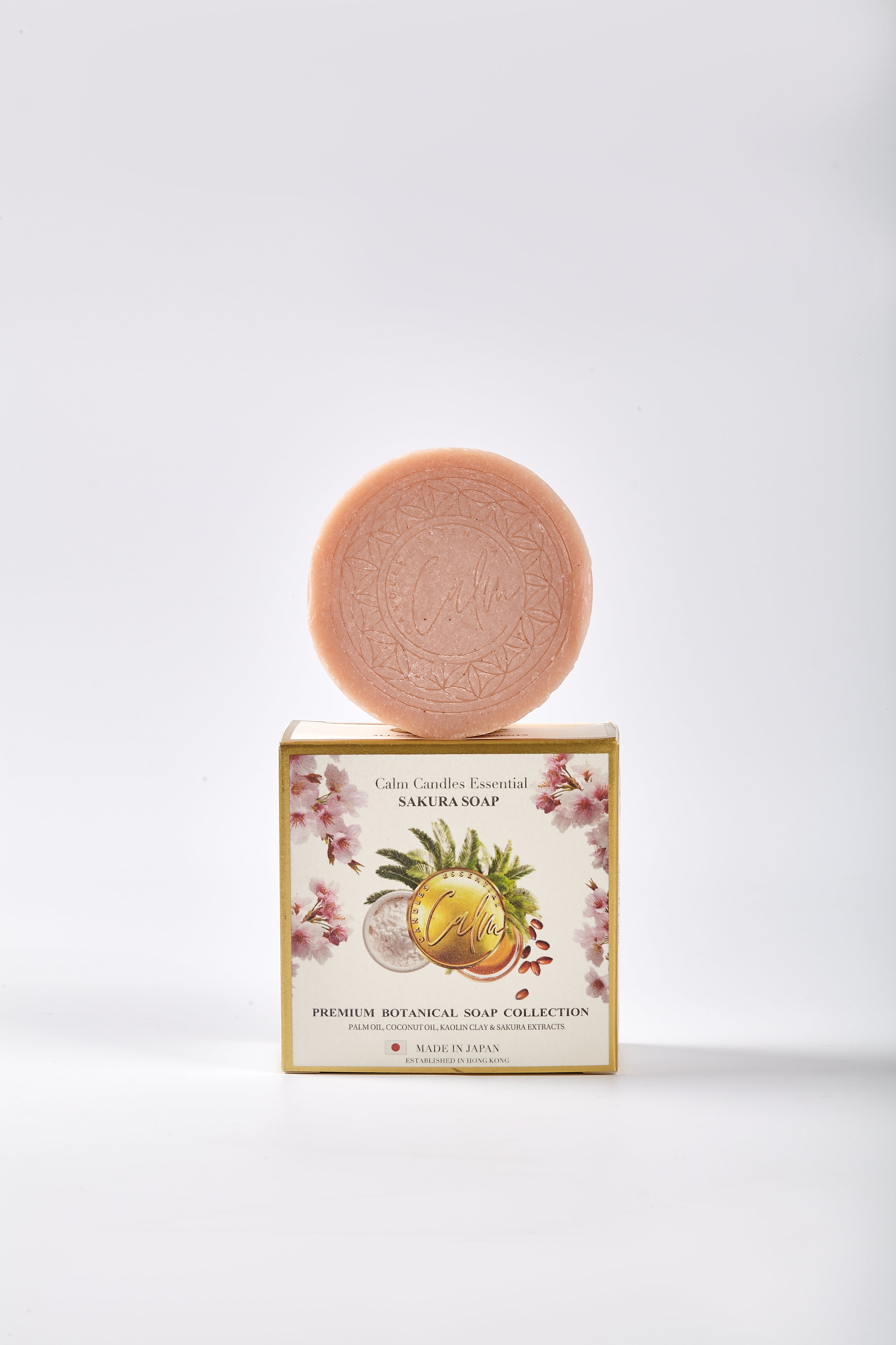 Pink soap bar on a decorative soap box with floral design on a white background